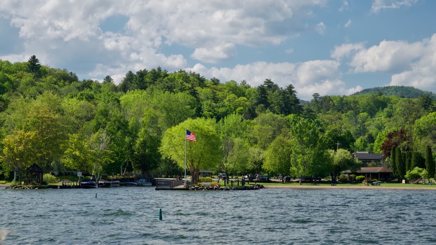 Hague's town beach and boat launch, the American flag flying over docks and the lakeside hamlet